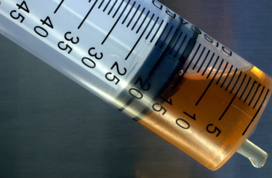 Close-up of brown oil in syringe